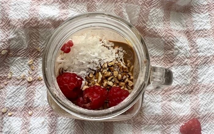 Breakfast meal prep overnight oats with raspberries, coconut, chopped nuts